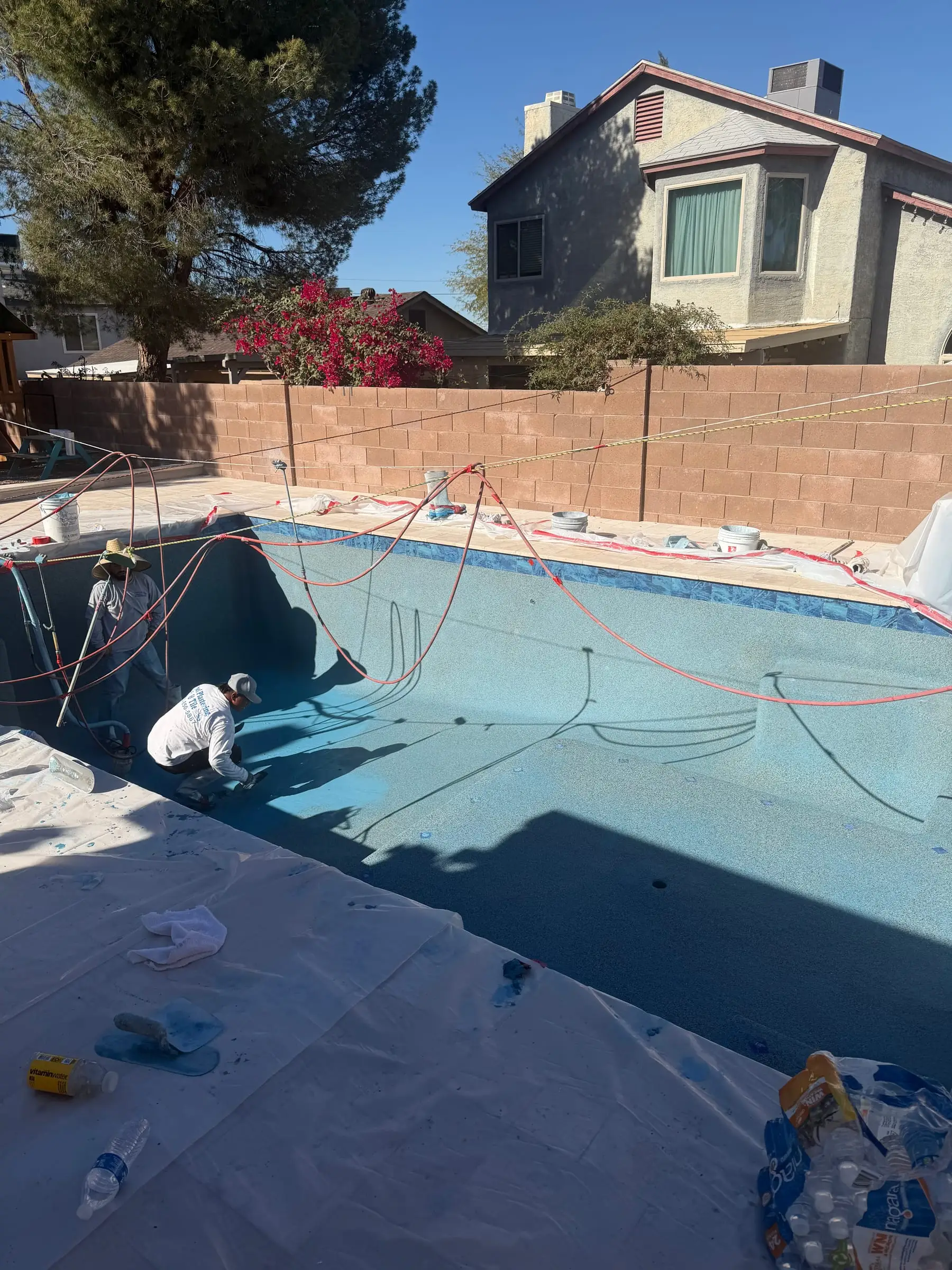 Our crew applying a blue interior finish, with the deck covered for protection.