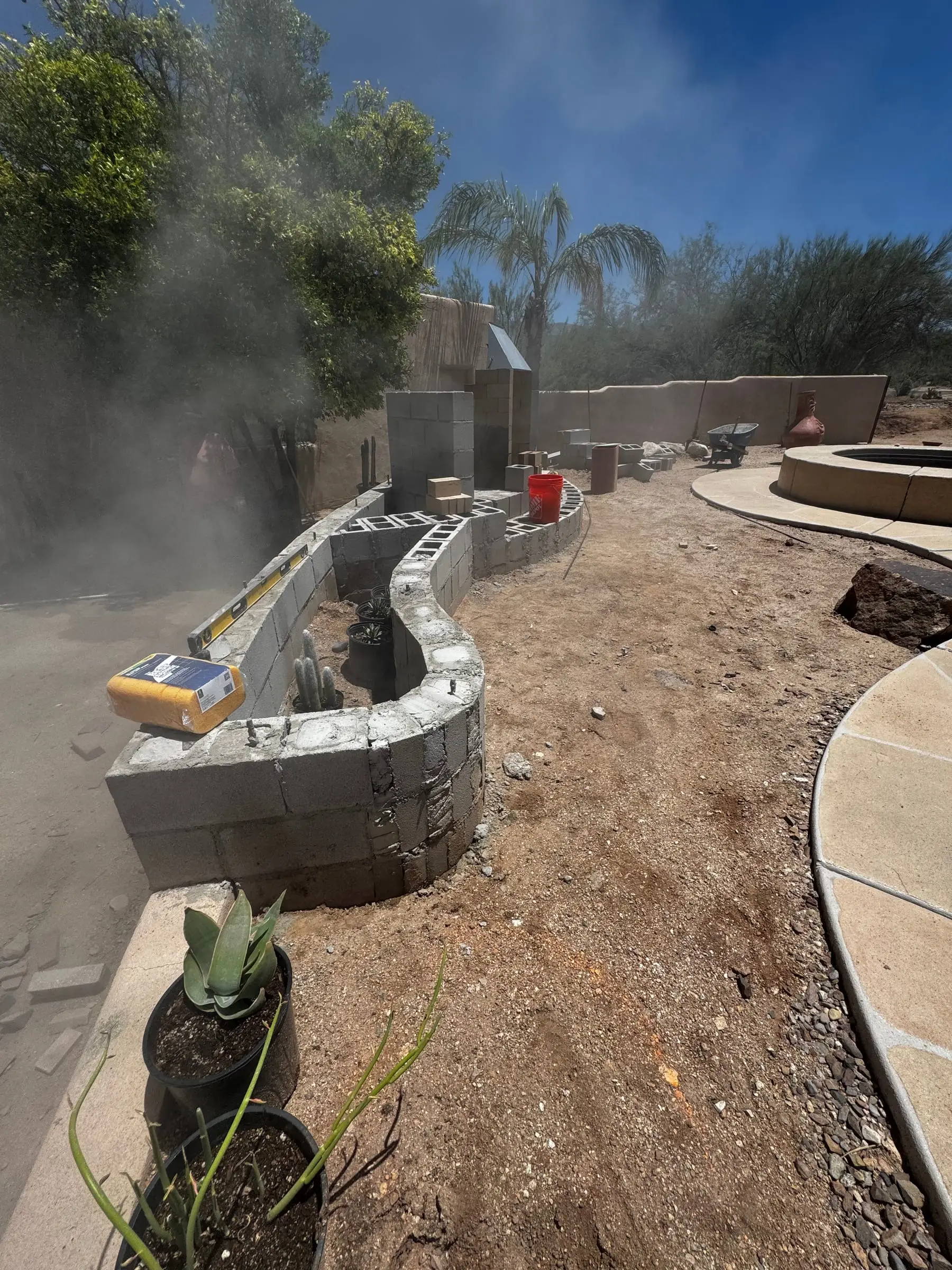Curved block seat wall going up along a new backyard path, east Tucson, AZ.