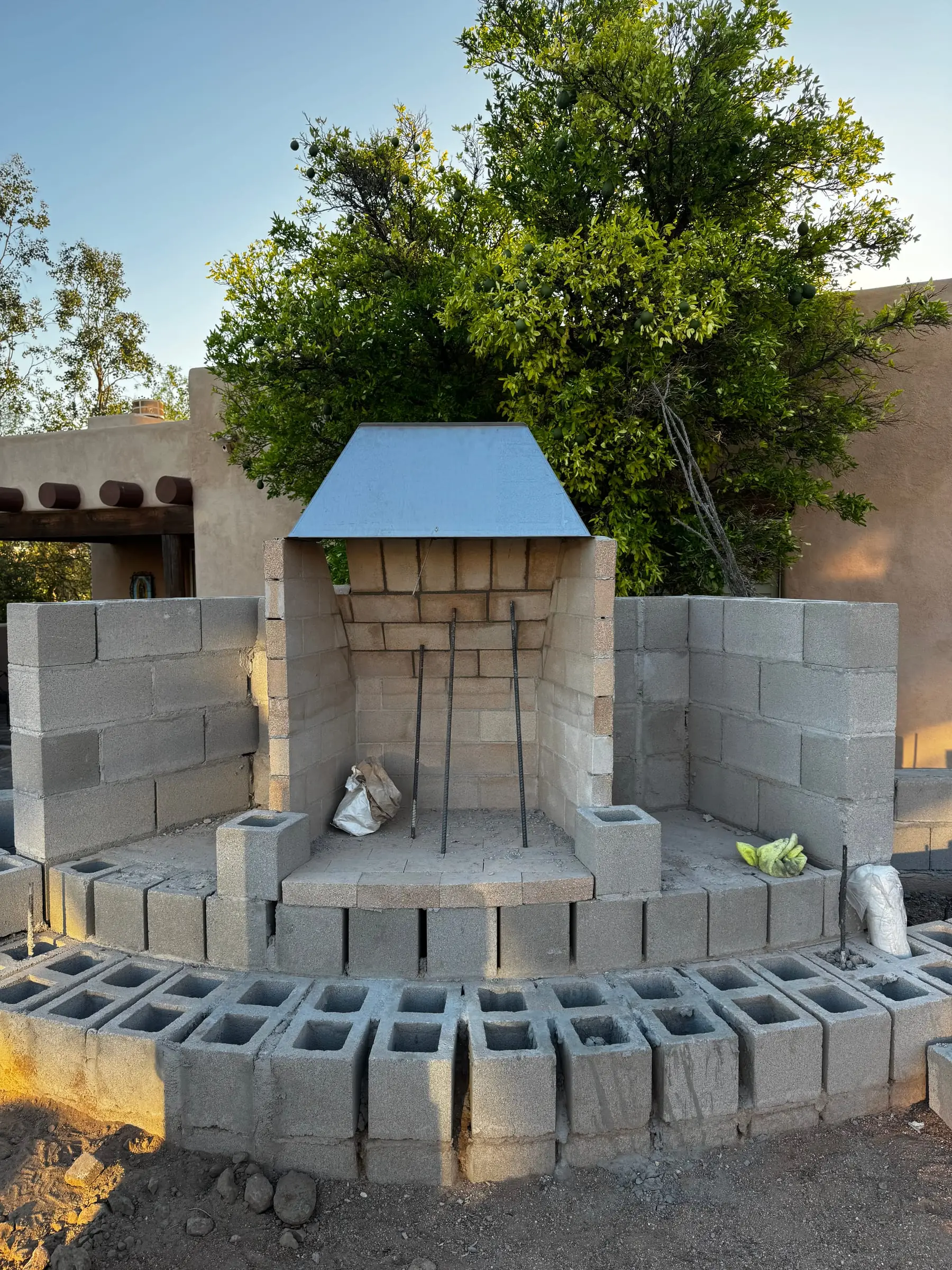 Block frame of an outdoor fireplace with a curved seat wall base, east Tucson, AZ.