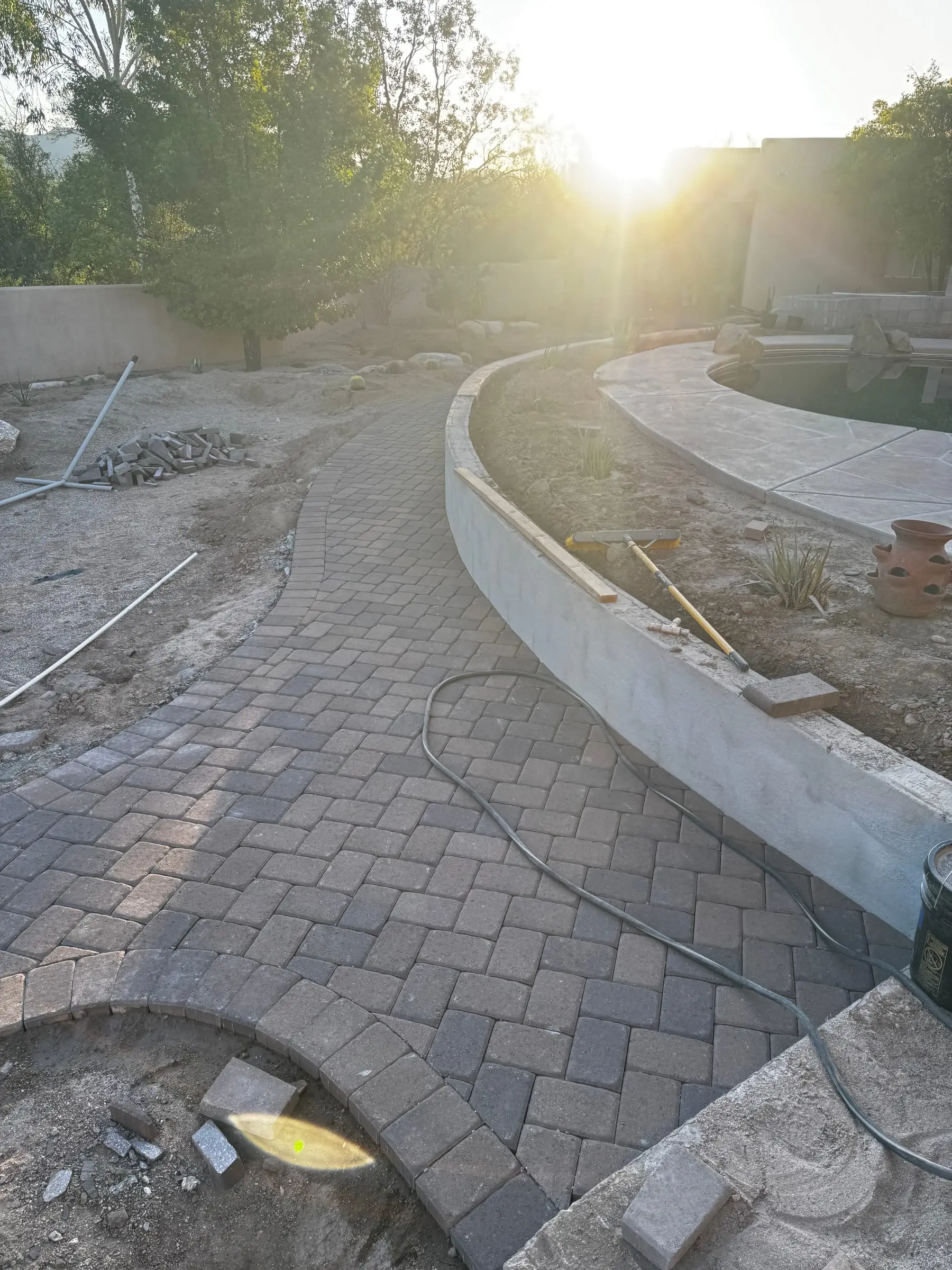 New paver walkway curving beside a block seat wall, east Tucson, AZ.