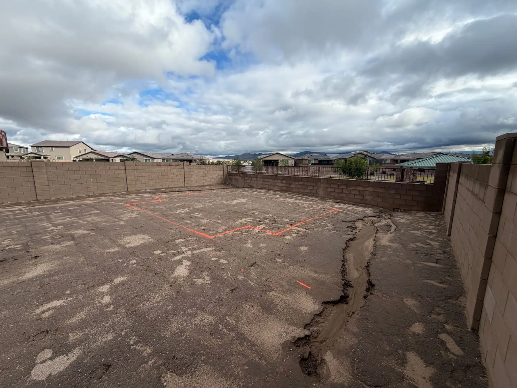 Pool layout painted on a graded backyard in a newer Marana neighborhood.