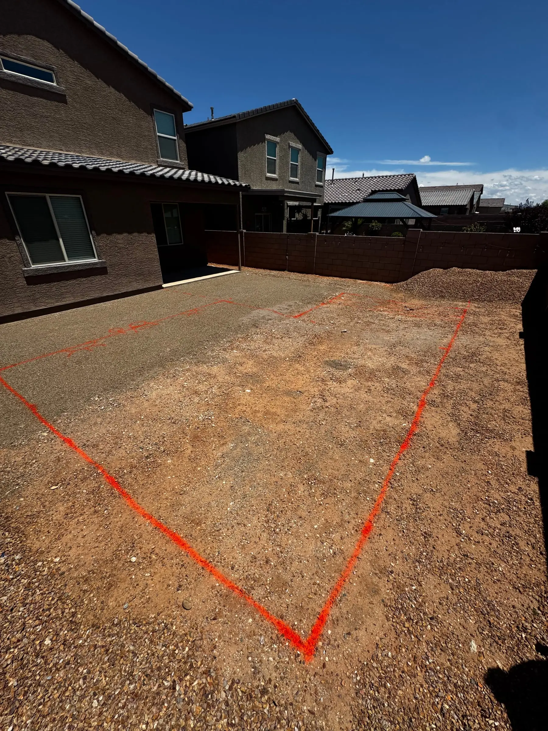Pool outline painted on a graded backyard behind a new two-story home, southeast Tucson, AZ.