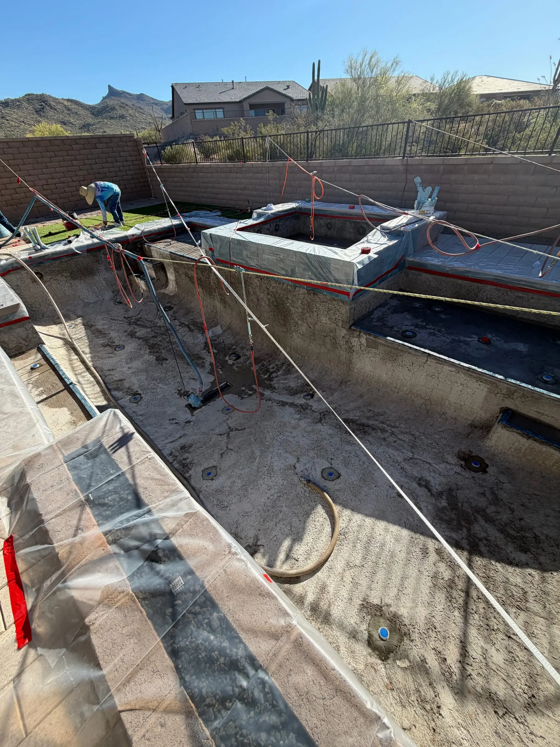 Pool and raised spa shell taped and ready for the interior finish, with mountains behind, Marana, AZ.