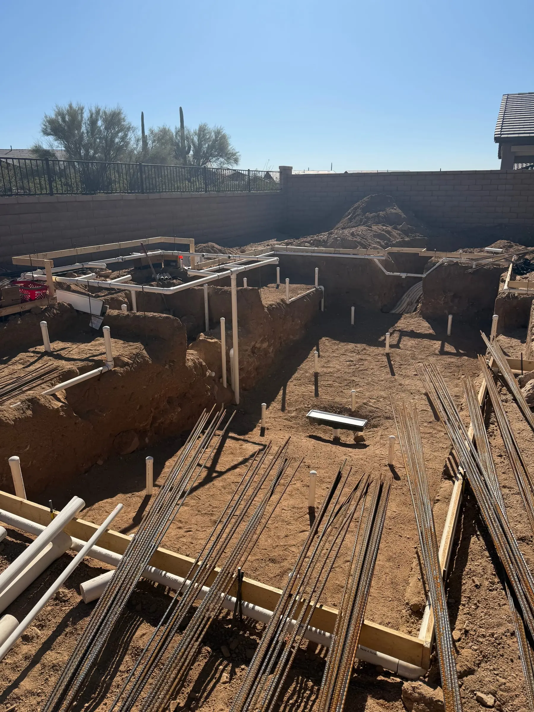 Rebar bundles and wood forms set in a pool and spa excavation, Marana, AZ.