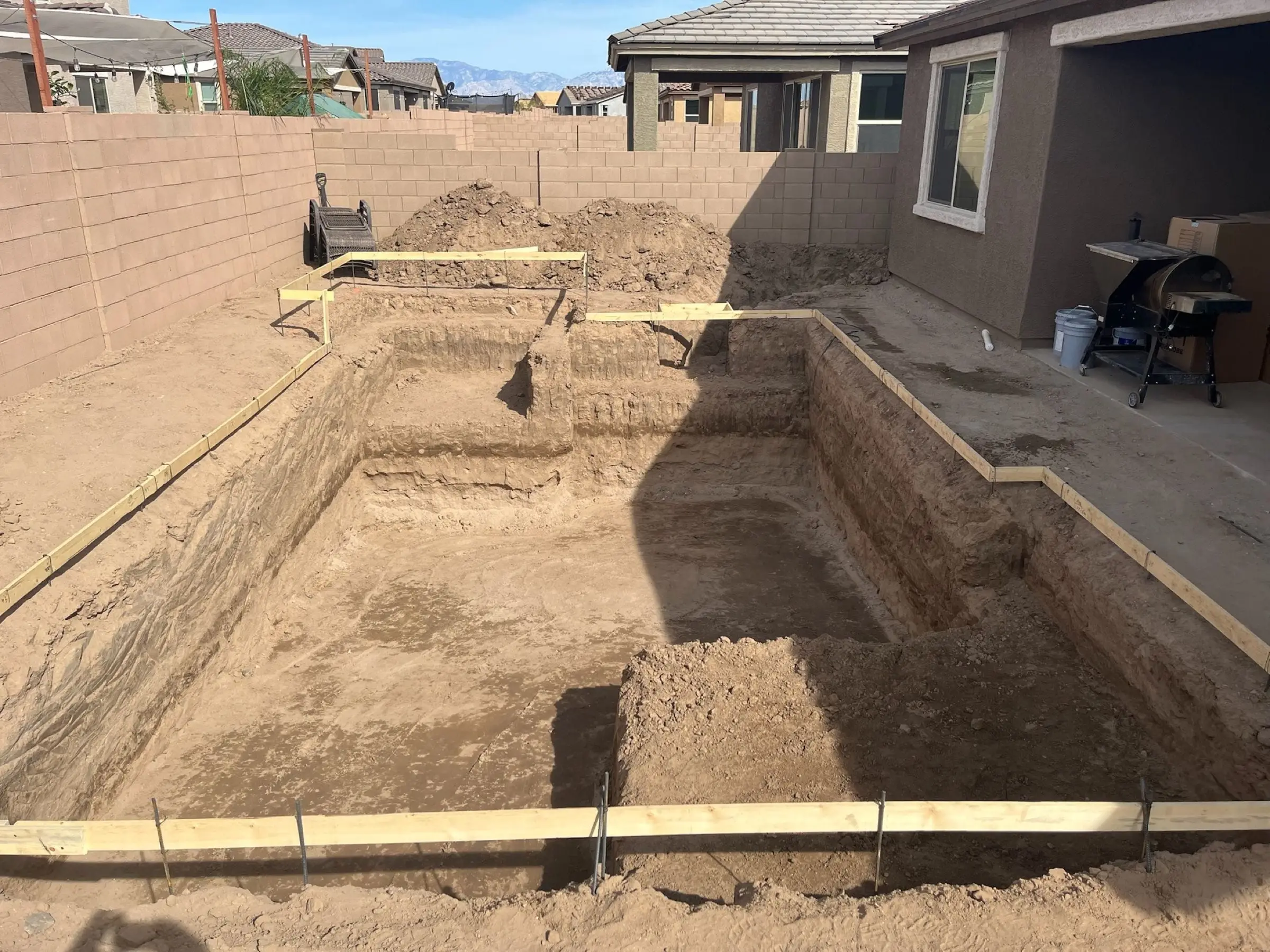 Rectangular pool excavation with wood forms and stepped cuts for the shallow end, Marana, AZ.
