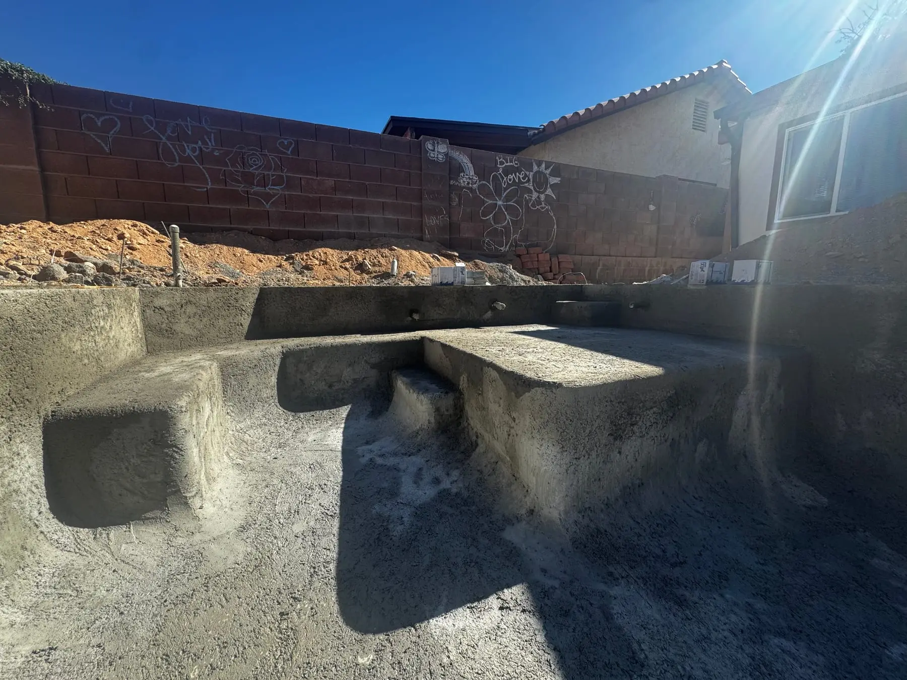 Shotcrete pool shell with a built-in bench seat at the shallow end, northwest Tucson, AZ.