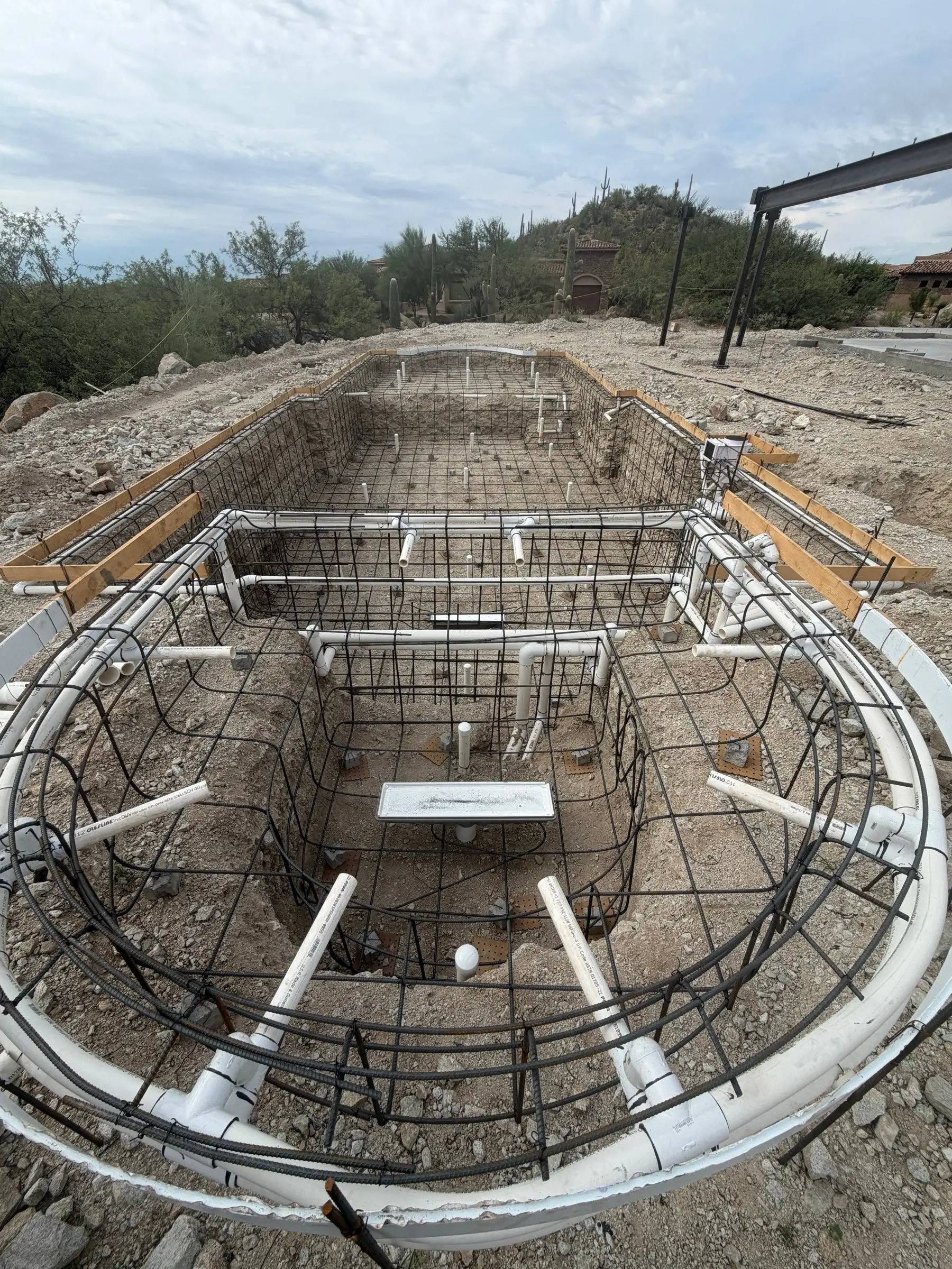 Close view of spa steel cage with jet and return plumbing lines before shotcrete