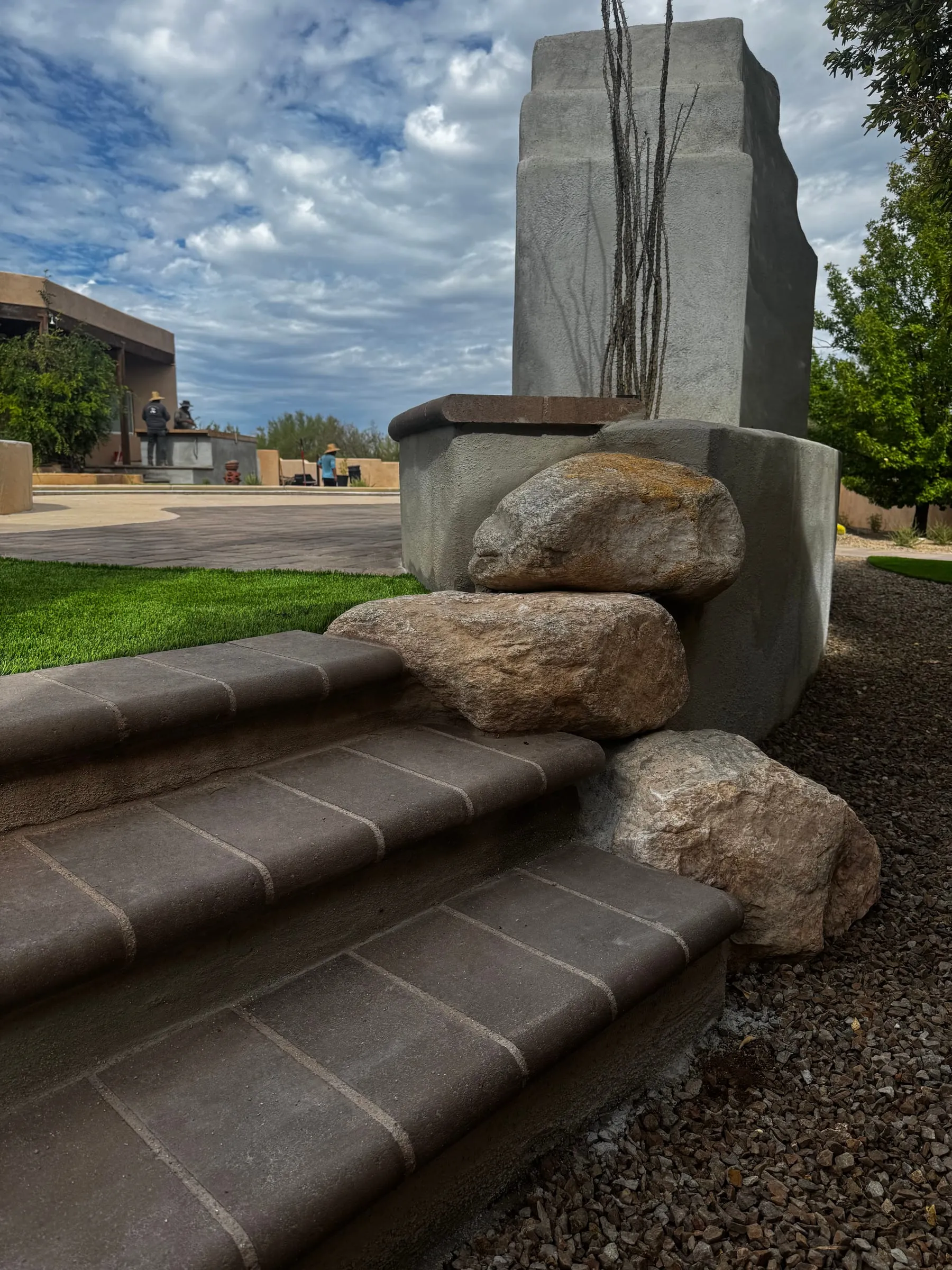 Capped steps and boulders finishing a backyard hardscape project in east Tucson.